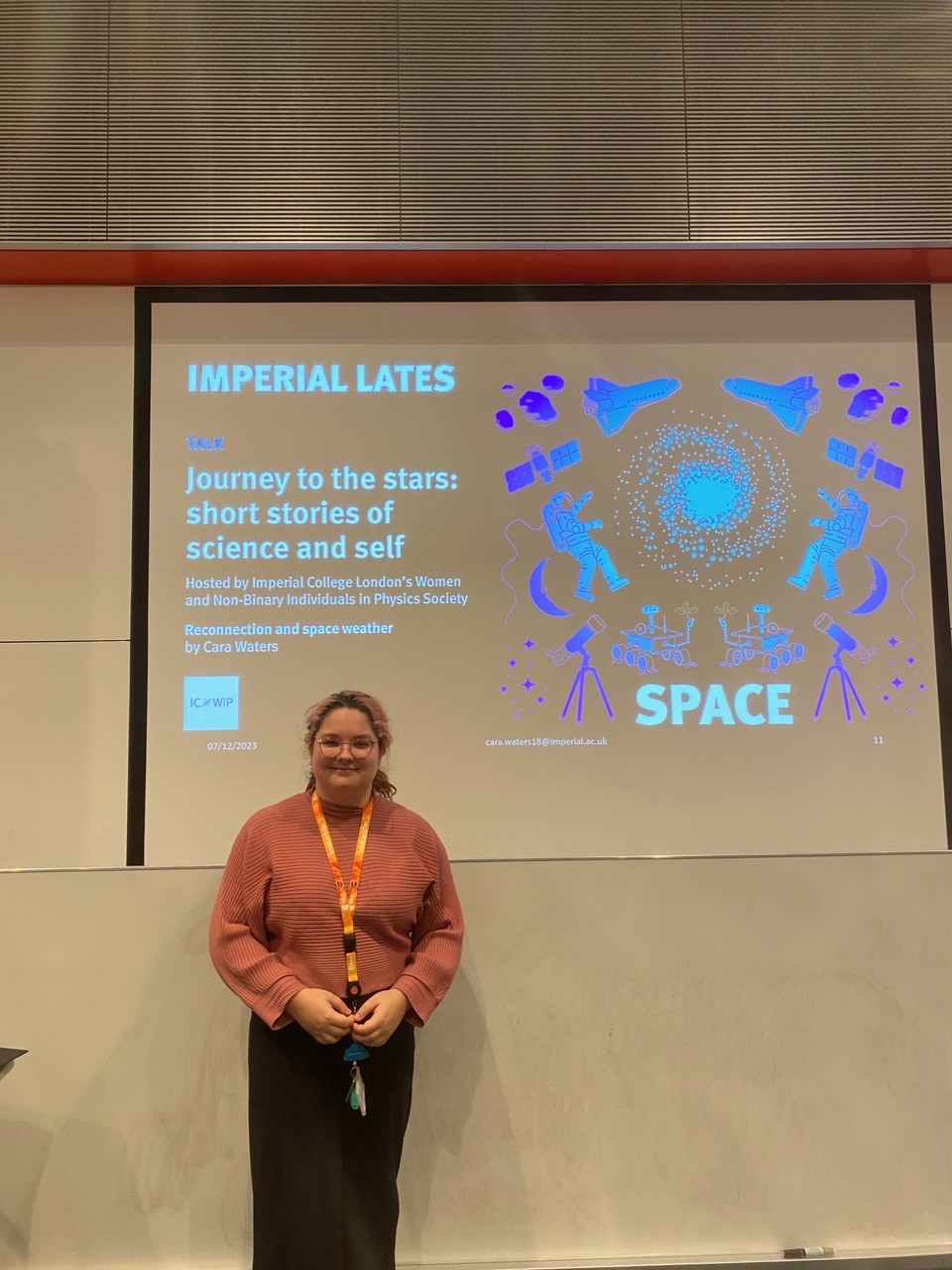 Me standing in front of slides titled "Reconnection and Space Weather" for Women in Physics